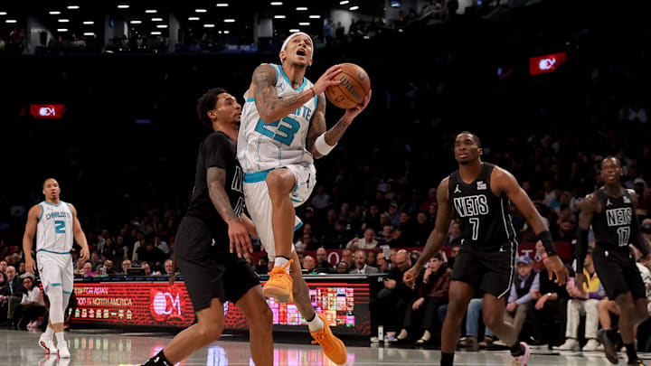 Nov 19, 2024; Brooklyn, New York, USA; Charlotte Hornets guard Tre Mann (23) drives to the basket against Brooklyn Nets guards Keon Johnson (45) and Shake Milton (7) during the second quarter at Barclays Center. Mandatory Credit: Brad Penner-Imagn Images Nov 19, 2024; Brooklyn, New York, USA; Charlotte Hornets guard Tre Mann (23) drives to the basket against Brooklyn Nets guards Keon Johnson (45) and Shake Milton (7) during the second quarter at Barclays Center. Mandatory Credit: Brad Penner-Imagn Images