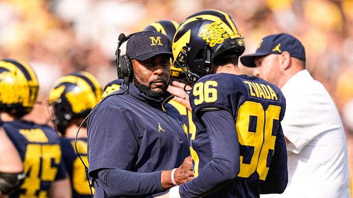 Michigan head coach Sherrone Moore shakes hands with place kicker Dominic Zvada (96) after an extra point against Washington during the second half at Michigan Stadium in Ann Arbor on Saturday, Oct. 18, 2025.