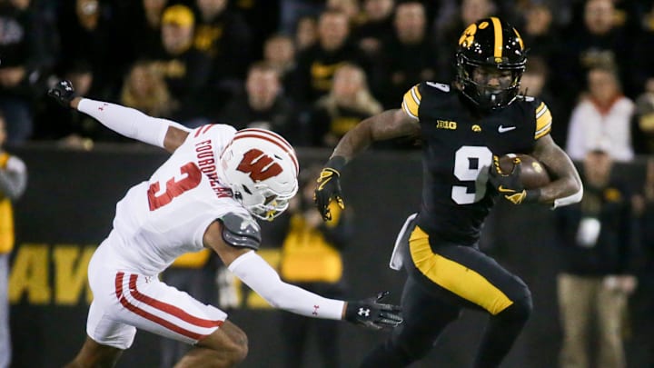 Iowa’s running back Jaziun Patterson (9) carries the ball as Wisconsin’s Nyzier Fourqurean (3) pursues Saturday, Nov. 2, 2024 at Kinnick Stadium in Iowa City, Iowa.