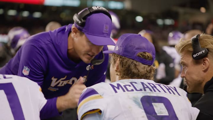 Kevin O'Connell talks to J.J. McCarthy on the sideline during Monday night's win over the Bears.