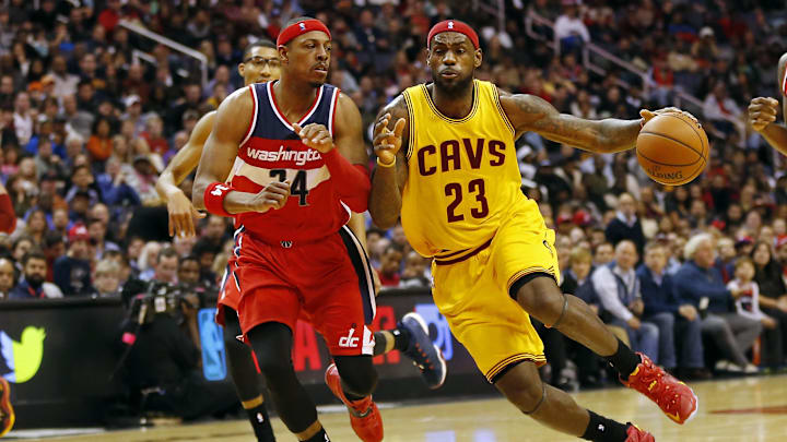 Nov 21, 2014; Washington, DC, USA; Cleveland Cavaliers forward LeBron James (23) dribbles the ball as Washington Wizards forward Paul Pierce (34) defends in the third quarter at Verizon Center. The Wizards won 91-78. Mandatory Credit: Geoff Burke-Imagn Images