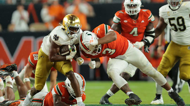 Aug 31, 2025; Miami Gardens, Florida, USA; Notre Dame Fighting Irish running back Jadarian Price (24) rushes the ball past Miami Hurricanes defensive lineman Akheem Mesidor (3) during the second quarter at Hard Rock Stadium. Mandatory Credit: Sam Navarro-Imagn Images Aug 31, 2025; Miami Gardens, Florida, USA; Notre Dame Fighting Irish running back Jadarian Price (24) rushes the ball past Miami Hurricanes defensive lineman Akheem Mesidor (3) during the second quarter at Hard Rock Stadium. Mandatory Credit: Sam Navarro-Imagn Images