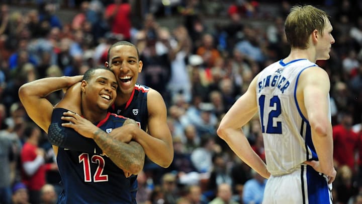March 24, 2011; Anaheim, CA, USA; Arizona Wildcats forward Derrick Williams (rear) and guard Lamont Jones (left) celebrate after Jones draws a foul against Duke Blue Devils forward Kyle Singler (right) during the second half of the semi finals of the west regional of the 2011 NCAA men's basketball tournament at the Honda Center. Mandatory Credit: Gary A. Vasquez-Imagn Images