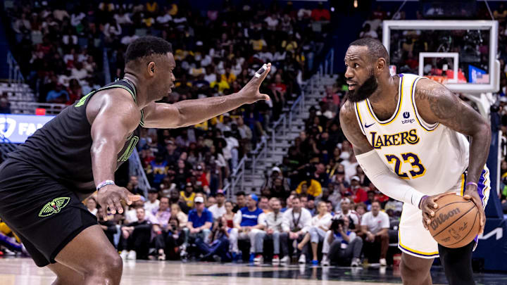 Apr 14, 2024; New Orleans, Louisiana, USA; Los Angeles Lakers forward LeBron James (23) dribbles against New Orleans Pelicans forward Zion Williamson (1) during the second half at Smoothie King Center. Mandatory Credit: Stephen Lew-Imagn Images