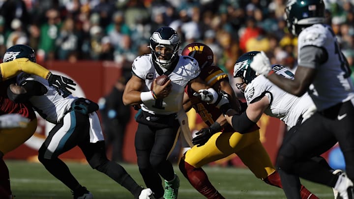 Dec 22, 2024; Landover, Maryland, USA; Philadelphia Eagles quarterback Jalen Hurts (1) runs with the ball past Washington Commanders linebacker Bobby Wagner (54) during the first quarter at Northwest Stadium. Mandatory Credit: Geoff Burke-Imagn Images