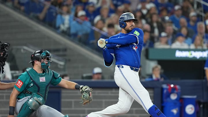 Oct 12, 2025; Toronto, Ontario, CAN; Toronto Blue Jays right fielder Anthony Santander (25) hits a single against the Seattle Mariners in the second inning during game one of the ALCS round for the 2025 MLB playoffs at Rogers Centre. Mandatory Credit: Nick Turchiaro-Imagn Images