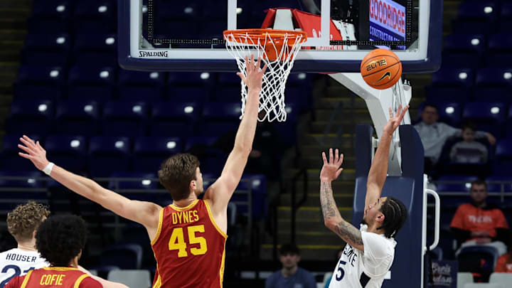 Penn State Nittany Lions guard Freddie Dilione V (5) shoots the ball as USC Trojans center Gabe Dynes (45) defends during the second half at Bryce Jordan Center. 