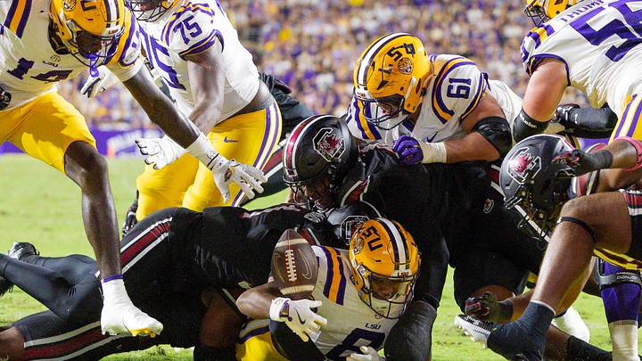 Oct 11, 2025; Baton Rouge, Louisiana, USA; South Carolina Gamecocks defensive lineman Monkell Goodwine (44) forces a fumble at the 1 yard line by LSU Tigers running back Ju'Juan Johnson (8) during the first half at Tiger Stadium. Mandatory Credit: Stephen Lew-Imagn Images Oct 11, 2025; Baton Rouge, Louisiana, USA; South Carolina Gamecocks defensive lineman Monkell Goodwine (44) forces a fumble at the 1 yard line by LSU Tigers running back Ju'Juan Johnson (8) during the first half at Tiger Stadium. Mandatory Credit: Stephen Lew-Imagn Images