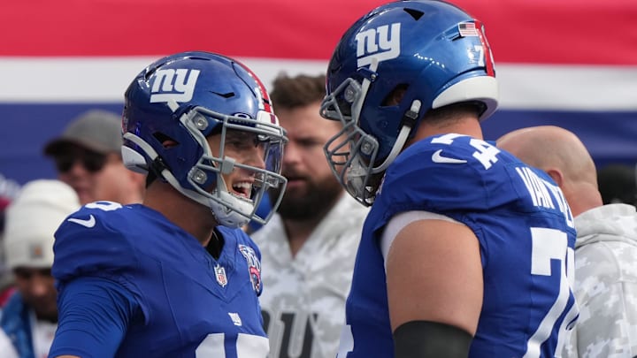 East Rutherford, NJ -- November 24, 2024 -- Tommy DeVito with Greg Van Roten of the Giants during warm-ups before the game. The Tampa Bay Buccaneers came to MetLife Stadium to play the New York Giants.