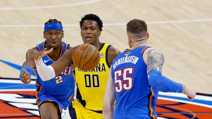 Oklahoma City Thunder guard Shai Gilgeous-Alexander and center Isaiah Hartenstein and Indiana Pacers guard Bennedict Mathurin battle for the loose ball during the third quarter.ndatory Credit: Alonzo Adams-Imagn Images