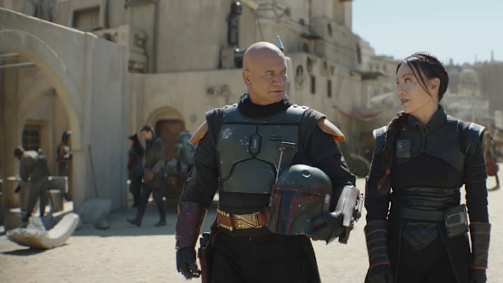 (L-R): Boba Fett (Temuera Morrison) and Fennec Shand (Ming-Na Wen) in Lucasfilm's THE BOOK OF BOBA FETT, exclusively on Disney+. © 2022 Lucasfilm Ltd. & ™. All Rights Reserved.