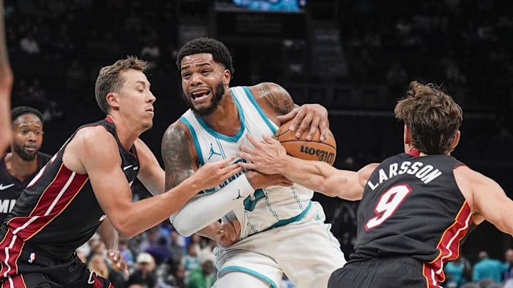 Oct 8, 2024; Charlotte, North Carolina, USA; Charlotte Hornets forward Miles Bridges (0) is fouled on his way to the basket by Miami Heat forward Duncan Robinson (55) and guard Pelle Larsson (9) during the second half at Spectrum Center. Oct 8, 2024; Charlotte, North Carolina, USA; Charlotte Hornets forward Miles Bridges (0) is fouled on his way to the basket by Miami Heat forward Duncan Robinson (55) and guard Pelle Larsson (9) during the second half at Spectrum Center.