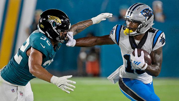 Carolina Panthers wide receiver John Metchie III (13) stiff arms Jacksonville Jaguars linebacker Jahlani Tavai Carolina Panthers wide receiver John Metchie III (13) stiff arms Jacksonville Jaguars linebacker Jahlani Tavai