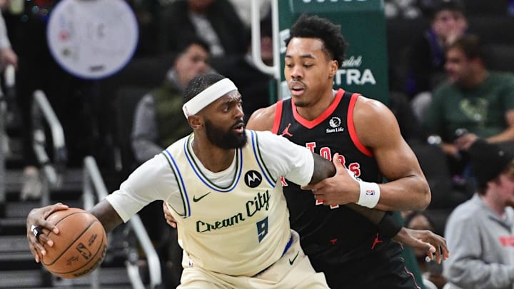 Dec 18, 2025; Milwaukee, Wisconsin, USA; Milwaukee Bucks forward Bobby Portis (9) dribbles against Toronto Raptors guard Scottie Barnes (4) in the second quarter at Fiserv Forum. Mandatory Credit: Benny Sieu-Imagn Images