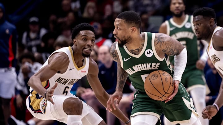 Mar 28, 2024; New Orleans, Louisiana, USA;   Milwaukee Bucks guard Damian Lillard (0) dribbles against New Orleans Pelicans forward Herbert Jones (5) during the second half at Smoothie King Center. Mandatory Credit: Stephen Lew-Imagn Images
