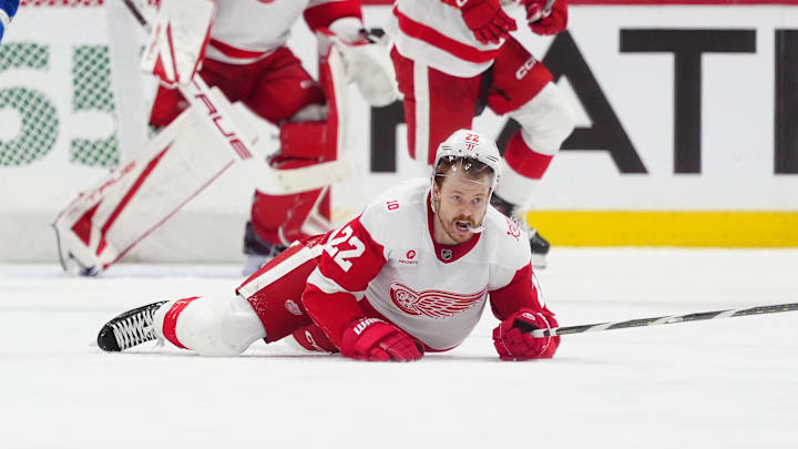 Feb 2, 2026; Denver, Colorado, USA; Detroit Red Wings center Mason Appleton (22) falls on the ice in the third period against the Colorado Avalanche at Ball Arena. Mandatory Credit: Ron Chenoy-Imagn Images