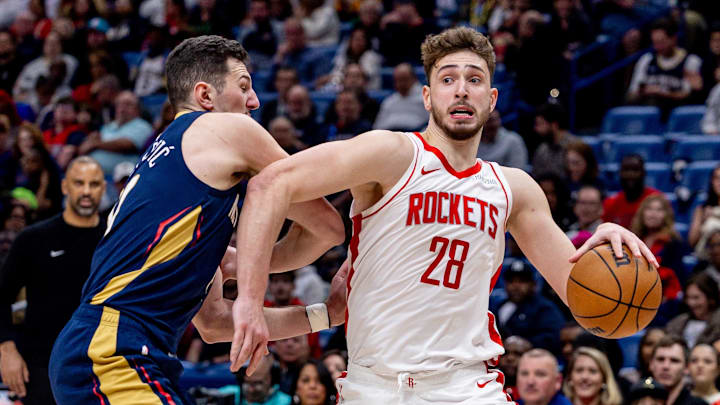 Mar 6, 2025; New Orleans, Louisiana, USA;  Houston Rockets center Alperen Sengun (28) dribbles against New Orleans Pelicans center Karlo Matkovic (17) during the second half at Smoothie King Center. Mandatory Credit: Stephen Lew-Imagn Images