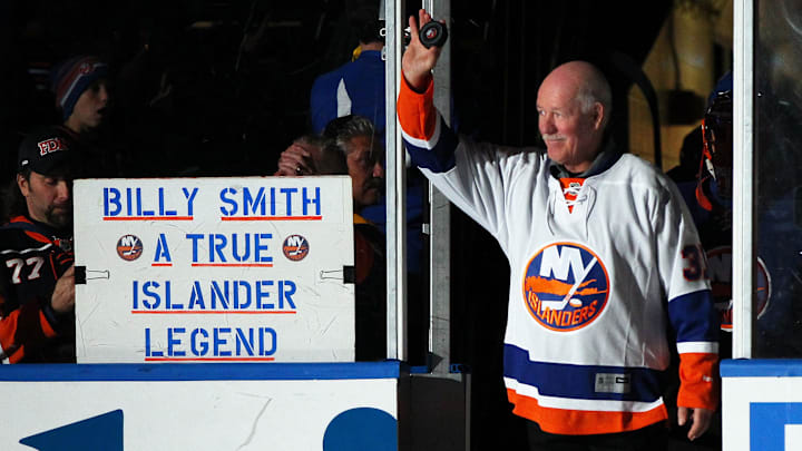 Nov 22, 2014; Uniondale, NY, USA; Former New York Islanders goaltender Billy Smith (R) leads the players onto the ice prior to the Islanders ' game against the Pittsburgh Penguins at Nassau Veterans Memorial Coliseum. Mandatory Credit: Andy Marlin-Imagn Images