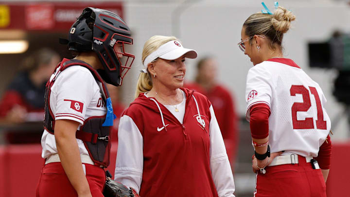 Oklahoma coach Patty Gasso, center, talks to pitcher Sam Landry (21) and catcher Isabela Emerling, left. Oklahoma coach Patty Gasso, center, talks to pitcher Sam Landry (21) and catcher Isabela Emerling, left.