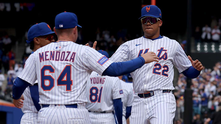 Apr 4, 2025; New York City, New York, USA; New York Mets manager Carlos Mendoza (64) greets right fielder Juan Soto (22) during introductions before the Mets home opener against the Toronto Blue Jays at Citi Field. Mandatory Credit: Brad Penner-Imagn Images