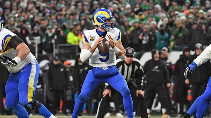 Jan 19, 2025; Philadelphia, Pennsylvania, USA; Los Angeles Rams quarterback Matthew Stafford (9) looks for a receiver against the Philadelphia Eagles in a 2025 NFC divisional round game at Lincoln Financial Field. Mandatory Credit: Eric Hartline-Imagn Images