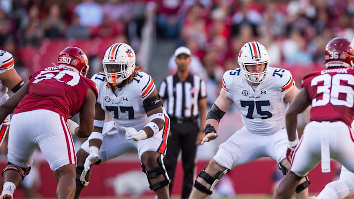Nov 11, 2023; Fayetteville, Arkansas, USA;  Auburn Tigers offensive lineman Jeremiah Wright (77) and