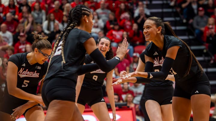 Nebraska's Harper Murray and Taylor Landfair celebrate during the its match against Indiana. Murray finished with 11 kills while Landfair added five. 