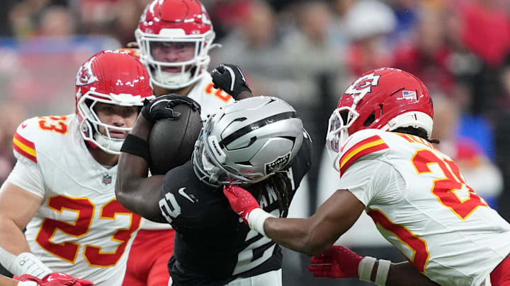 Jan 4, 2026; Paradise, Nevada, USA; Las Vegas Raiders running back Ashton Jeanty (2) carries the ball against Kansas City Chiefs linebacker Drue Tranquill (23) and cornerback Nohl Williams (20) in the first half at Allegiant Stadium. Mandatory Credit: Kirby Lee-Imagn Images