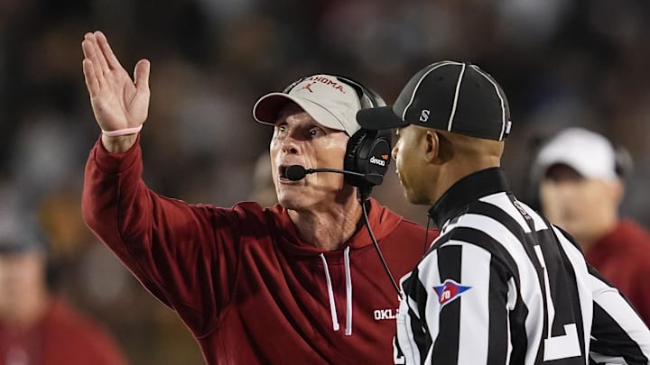Nov 9, 2024; Columbia, Missouri, USA; Oklahoma Sooners head coach Brent Venables talks with line judge Jeremiah Harris during the first half against the Missouri Tigers at Faurot Field at Memorial Stadium. Mandatory Credit: Jay Biggerstaff-Imagn Images