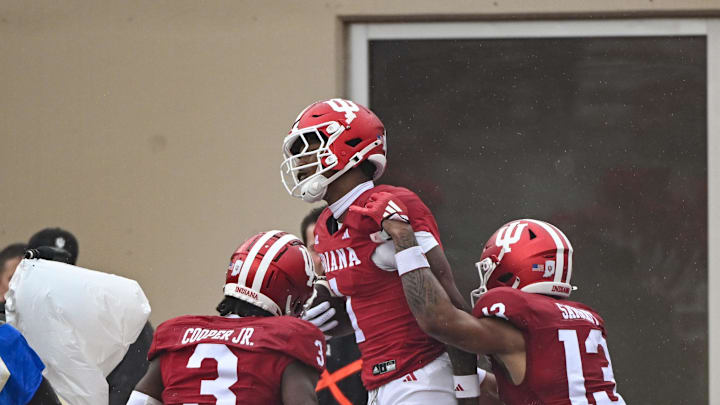 Sep 28, 2024; Bloomington, Indiana, USA;  Indiana Hoosiers wide receiver Donaven McCulley (1) celebrates with wide receiver Omar Cooper Jr. (3) and wide receiver Elijah Sarratt (13) after catching a pass for a touchdown against the Maryland Terrapins during the second half at Memorial Stadium. Mandatory Credit: Robert Goddin-Imagn Images