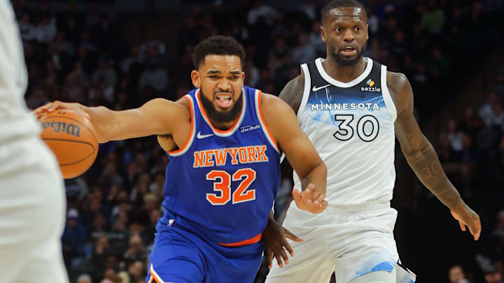 Dec 19, 2024; Minneapolis, Minnesota, USA; New York Knicks forward Karl-Anthony Towns (32) works around Minnesota Timberwolves forward Julius Randle (30) in the first quarter at Target Center. Mandatory Credit: Bruce Kluckhohn-Imagn Images