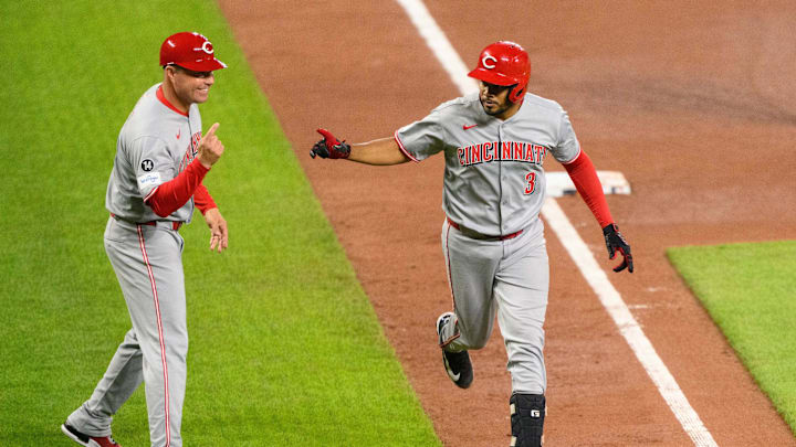 Apr 18, 2025; Baltimore, Maryland, USA; Cincinnati Reds third baseman Jeimer Candelario (3) celebrates with third base coach J.R. House (56) after a home run during the fourth inning against the Baltimore Orioles at Oriole Park at Camden Yards. Mandatory Credit: Reggie Hildred-Imagn Images