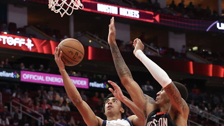 Mar 14, 2025; Houston, Texas, USA;  Dallas Mavericks guard Max Christie (00) shoots against Houston Rockets forward Jabari Smith Jr. (10) in the second half at Toyota Center. Mandatory Credit: Thomas Shea-Imagn Images