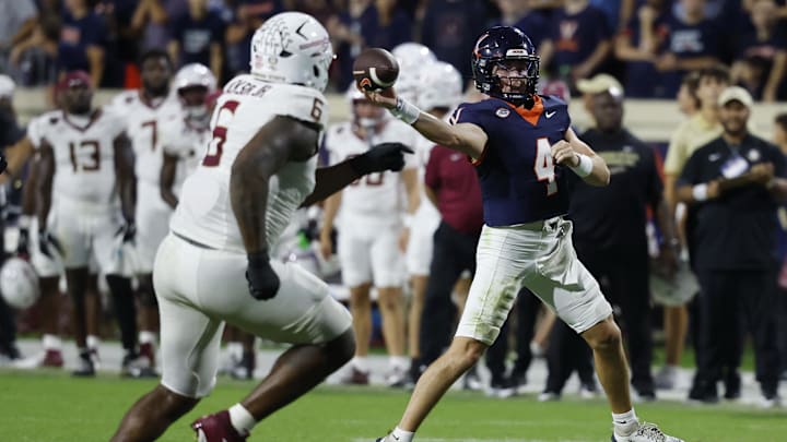 Sep 26, 2025; Charlottesville, Virginia, USA; Virginia Cavaliers quarterback Chandler Morris (4) passes the ball as Florida State Seminoles defensive lineman Darrell Jackson Jr. (6) chases at Scott Stadium. Mandatory Credit: Geoff Burke-Imagn Images
