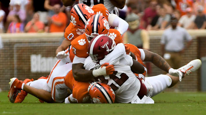Clemson Tigers linebacker Jamal Anderson (0), Clemson Tigers defensive end T.J. Parker (3) and Clemson Tigers defensive tackle Peter Woods (11) tackle Troy Trojans running back Tae Meadows (22) Saturday, Sept. 6, 2025 during the NCAA football game at Memorial Stadium in Clemson, South Carolina.