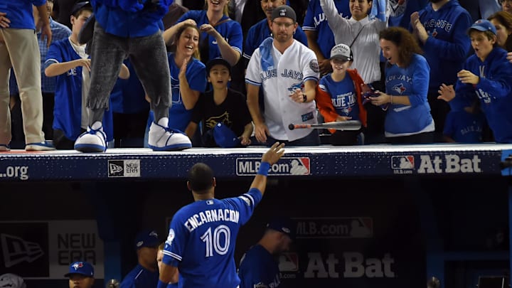 Toronto Blue Jays first baseman Edwin Encarnacion (10) gives a bat to a fan after the Cleveland Indians beat the Toronto Blue Jays in game five of the 2016 ALCS playoff baseball series at Rogers Centre. 