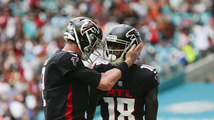 Oct 24, 2021; Miami Gardens, Florida, USA; Atlanta Falcons wide receiver Calvin Ridley (18) gets a tap on the helmet from quarterback Matt Ryan (2) after scoring a touchdown against the Miami Dolphins during the second quarter of the game at Hard Rock Stadium. Mandatory Credit: Sam Navarro-Imagn Images