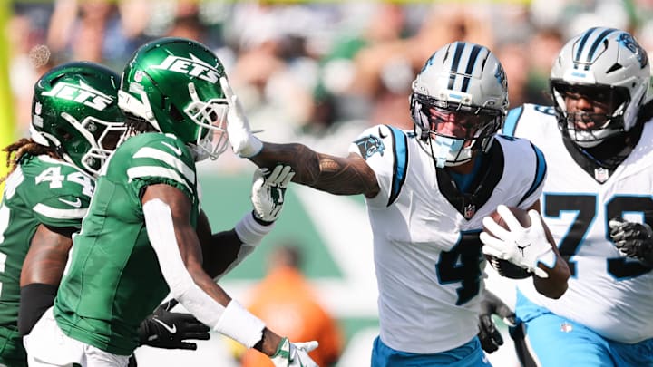 Oct 19, 2025; East Rutherford, New Jersey, USA; Carolina Panthers wide receiver Tetairoa McMillan (4) stiff arms New York Jets cornerback Sauce Gardner (1) in the second quarter at MetLife Stadium. Mandatory Credit: Vincent Carchietta-Imagn Images Oct 19, 2025; East Rutherford, New Jersey, USA; Carolina Panthers wide receiver Tetairoa McMillan (4) stiff arms New York Jets cornerback Sauce Gardner (1) in the second quarter at MetLife Stadium. Mandatory Credit: Vincent Carchietta-Imagn Images