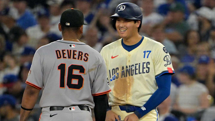 Sep 20, 2025; Los Angeles, California, USA;  Los Angeles Dodgers designated hitter Shohei Ohtani (17) talks with San Francisco Giants first baseman Rafael Devers (16) during the eighth inning at Dodger Stadium. Mandatory Credit: Jayne Kamin-Oncea-Imagn Images
