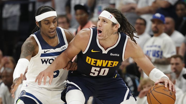 May 12, 2024; Minneapolis, Minnesota, USA; Denver Nuggets forward Aaron Gordon (50) works around Minnesota Timberwolves forward Jaden McDaniels (3) in the fourth quarter of game four of the second round for the 2024 NBA playoffs at Target Center.