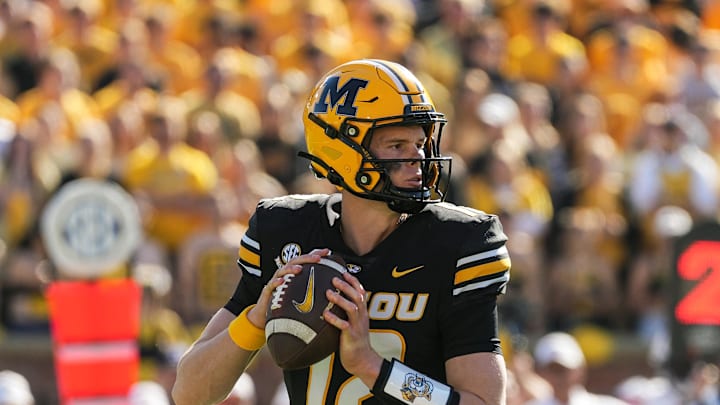 Oct 19, 2024; Columbia, Missouri, USA; Missouri Tigers quarterback Brady Cook (12) drops back to pass during the first half against the Auburn Tigers at Faurot Field at Memorial Stadium. Mandatory Credit: Jay Biggerstaff-Imagn Images Oct 19, 2024; Columbia, Missouri, USA; Missouri Tigers quarterback Brady Cook (12) drops back to pass during the first half against the Auburn Tigers at Faurot Field at Memorial Stadium. Mandatory Credit: Jay Biggerstaff-Imagn Images