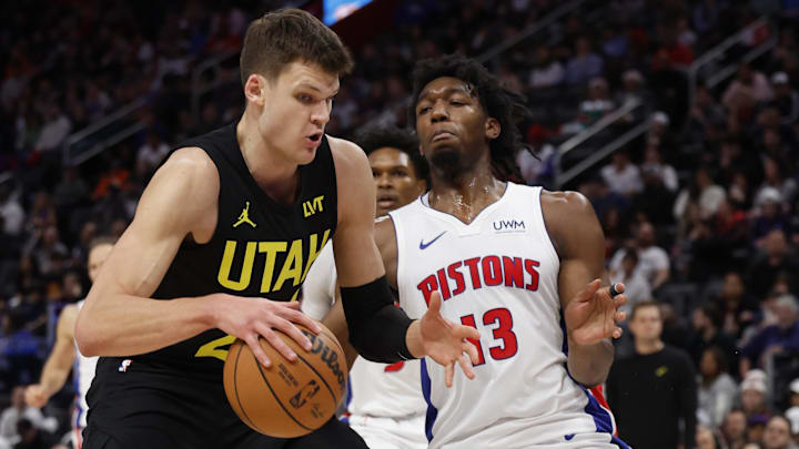 Dec 21, 2023; Detroit, Michigan, USA;  Utah Jazz center Walker Kessler (24) is defended by Detroit Pistons center James Wiseman (13) in the second half at Little Caesars Arena. Mandatory Credit: Rick Osentoski-USA TODAY Sports