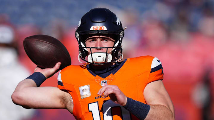 Nov 17, 2024; Denver, Colorado, USA;  Denver Broncos quarterback Bo Nix (10) warms before the game against the Atlanta Falcons at Empower Field at Mile High. Mandatory Credit: Ron Chenoy-Imagn Images