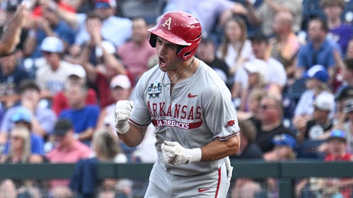 Jun 18, 2025; Omaha, Neb, USA;  Arkansas Razorbacks catcher Ryder Helfrick (27) circles the bases after hitting a home run against the LSU Tigers during the fourth inning at Charles Schwab Field. Mandatory Credit: Steven Branscombe-Imagn Images