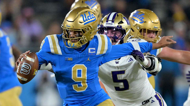 Nov 22, 2025; Pasadena, California, USA;  UCLA Bruins quarterback Nico Iamaleava (9) the grasp of Washington Huskies linebacker Zach Durfee (5) during the second half at the Rose Bowl. Mandatory Credit: Jayne Kamin-Oncea-Imagn Images