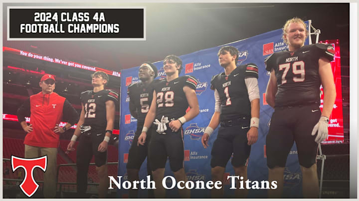 The North Oconee Titans await the Class 4A trophy presentation after defeating Marist Monday night in Mercedes-Benz Stadium. /GHSA