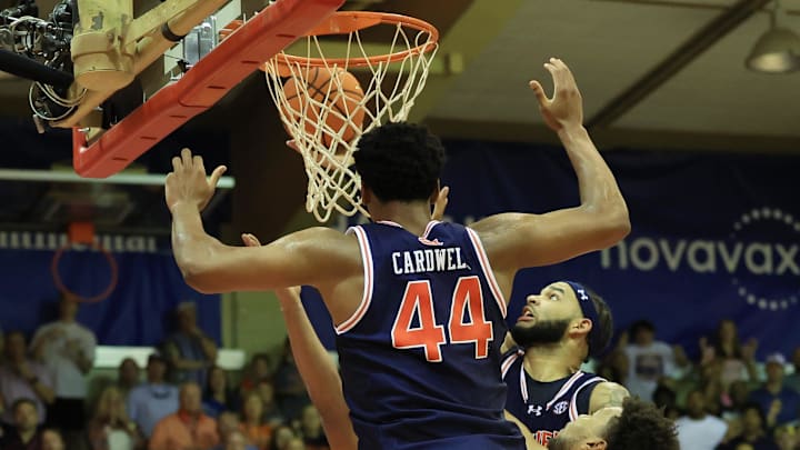 Nov 25, 2024; Lahaina, Hawaii, USA;  With seconds left on the clock, Auburn Tigers forward Johni Broome (4), in headband, makes a layup against the Iowa State Cyclones during the second half an NCAA college basketball game at Lahaina Civic Center. Auburn defeated Iowa State 83-81. Mandatory Credit: Marco Garcia-Imagn Images