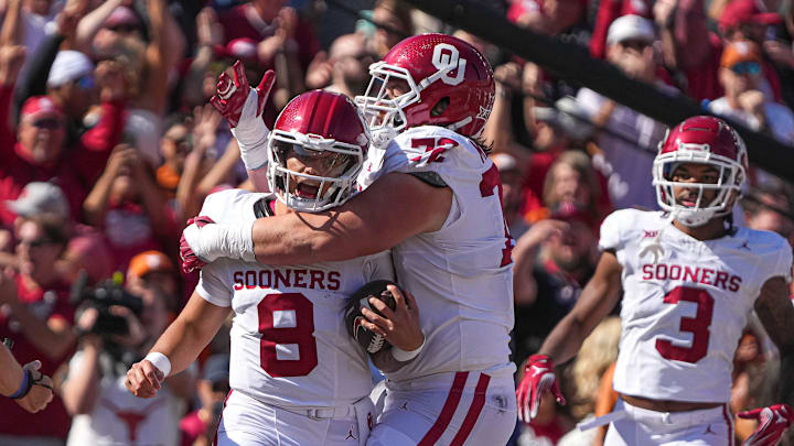 Oklahoma quarterback Dillon Gabriel (8) and offensive lineman McKade Mettauer (72) celebrate a