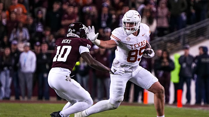 Nov 30, 2024; College Station, Texas, USA; Texas Longhorns tight end Gunnar Helm (85) attempts to break a tackle by Texas A&M defensive back Dezz Ricks (10) during the Lone Star Showdown at Kyle Field. Mandatory Credit: Sara Diggins/USA TODAY Network via Imagn Images Nov 30, 2024; College Station, Texas, USA; Texas Longhorns tight end Gunnar Helm (85) attempts to break a tackle by Texas A&M defensive back Dezz Ricks (10) during the Lone Star Showdown at Kyle Field. Mandatory Credit: Sara Diggins/USA TODAY Network via Imagn Images