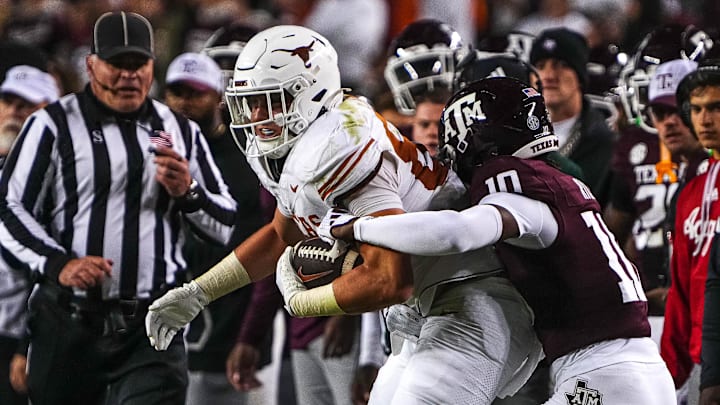 Nov 30, 2024; College Station, Texas, USA; Texas Longhorns tight end Gunnar Helm (85) is tackled by Texas A&M defensive back Dezz Ricks (10) during the Lone Star Showdown at Kyle Field. Mandatory Credit: Sara Diggins/USA TODAY Network via Imagn Images
